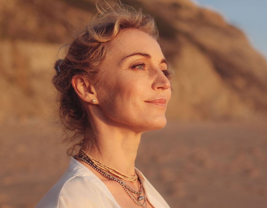 Mature woman at the beach at sunset
