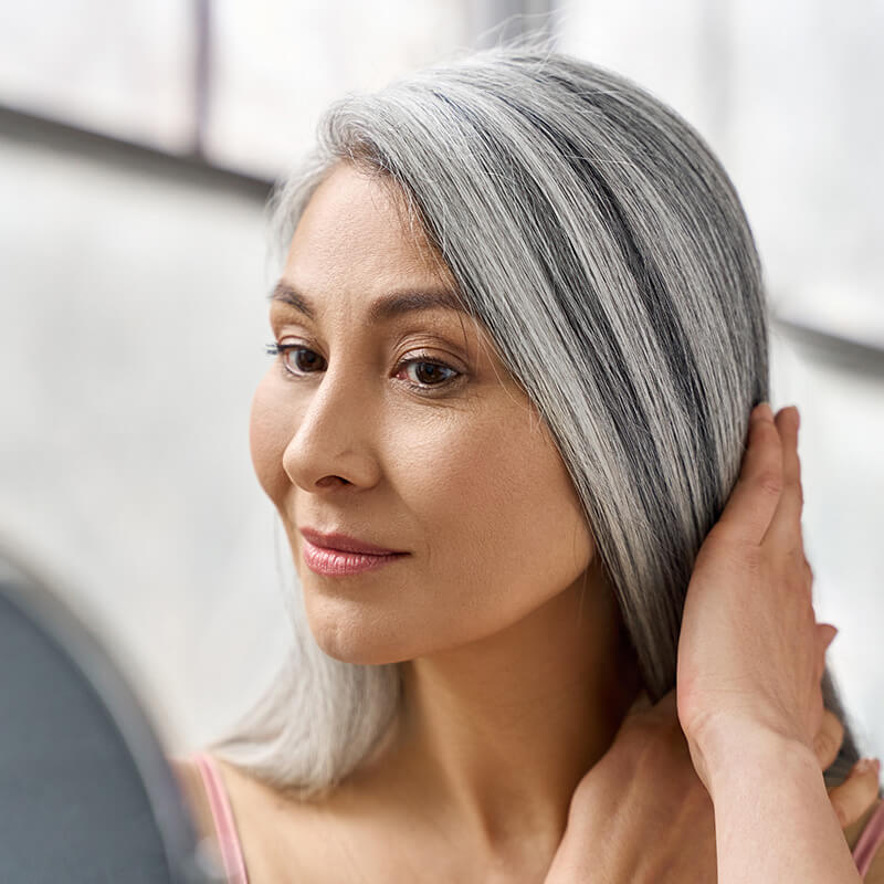 Mature woman looking in a mirror