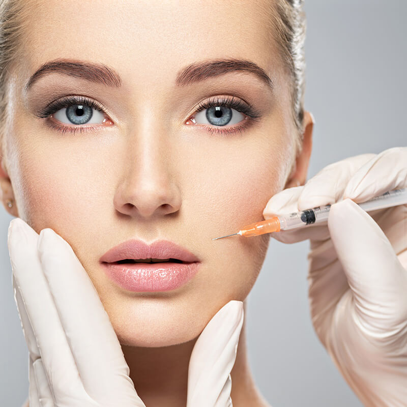 Beautiful woman getting face injection