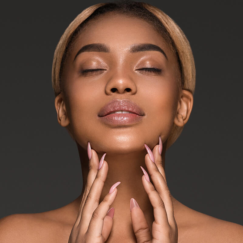 Young woman touching her face